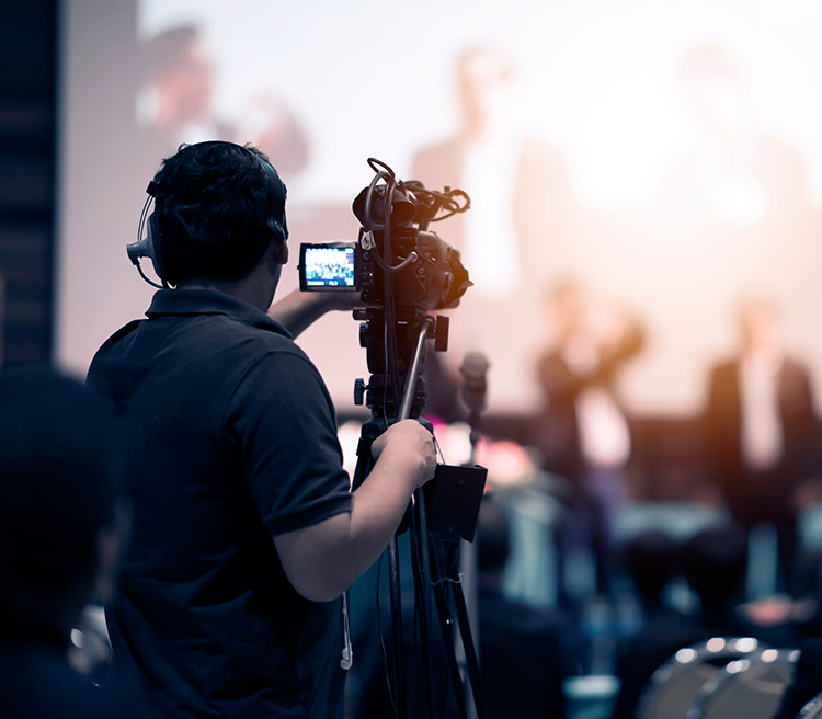 A videographer taping an event