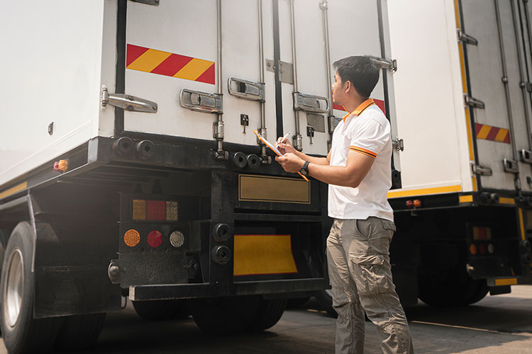 A logistics manager checking a trailer before the driver departs with the freight